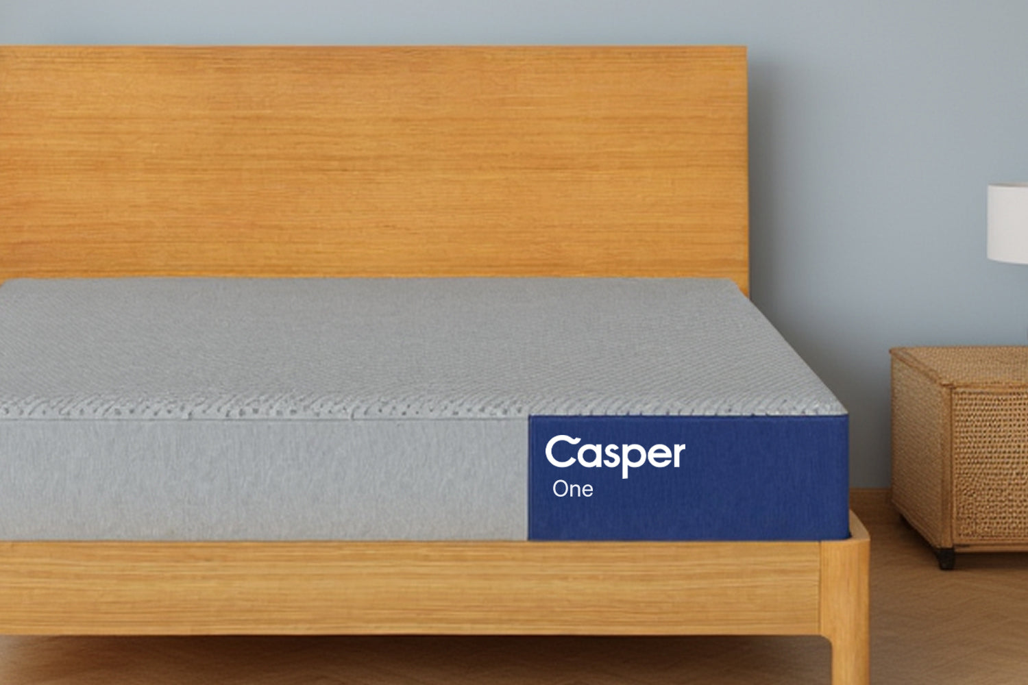 The One mattress on a wooden bed frame. Front view.