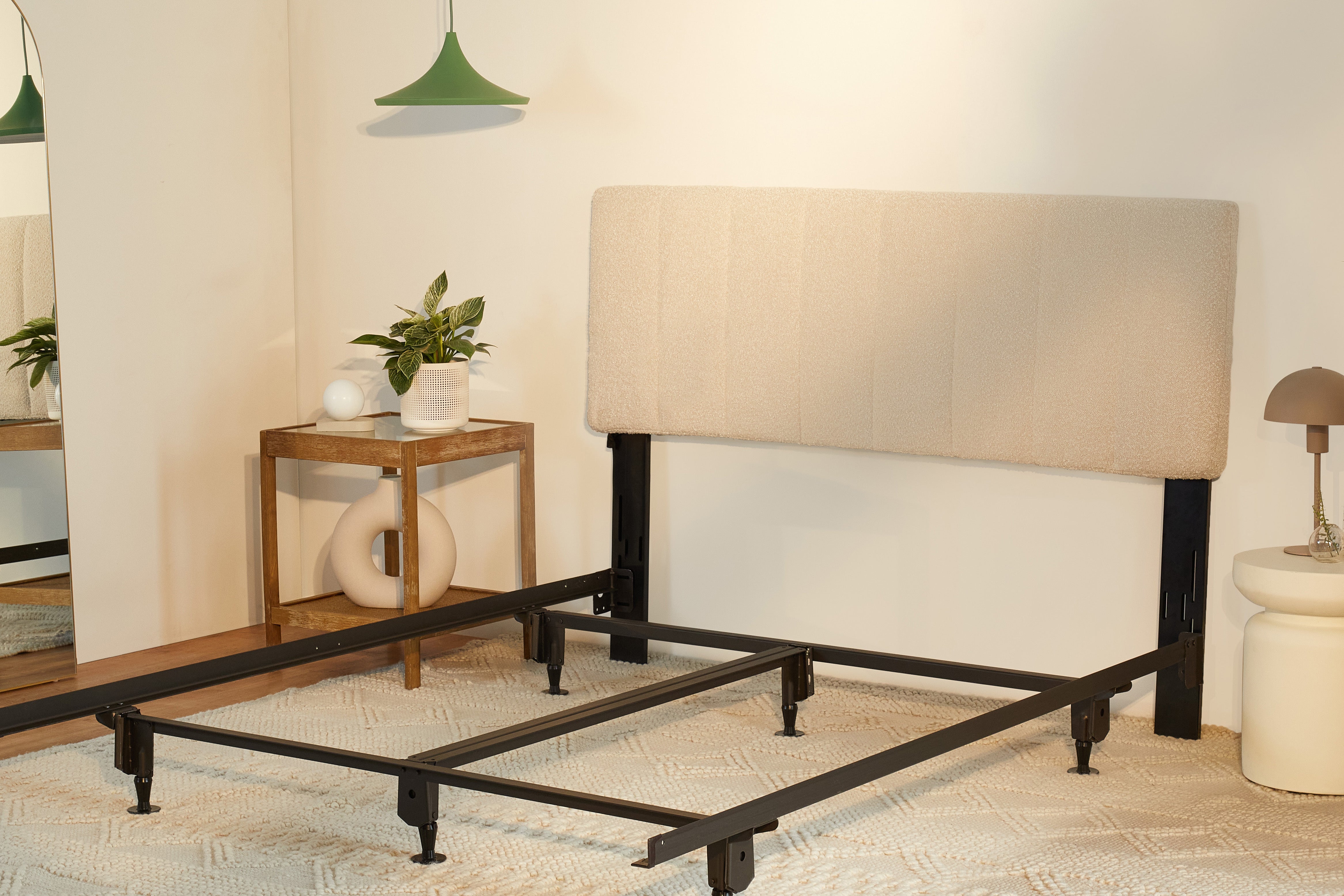 The Bliss Attachable Headboard, cream colored, attached to a metal bed frame
