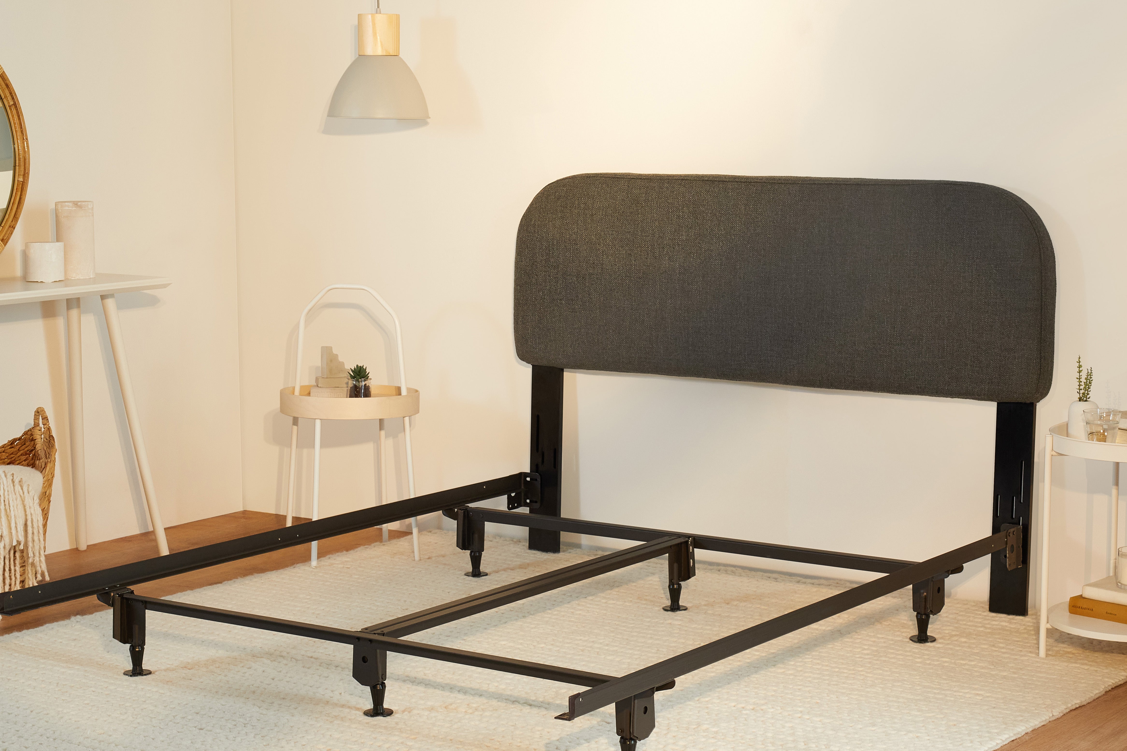 The Drift Attachable Headboard, slate colored, attached to a metal bed frame