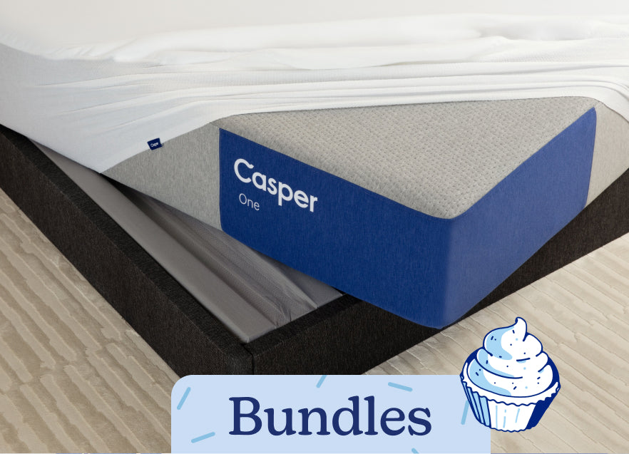Corner of a mattress on a bed frame with a mattress protector on it. The text 'Bundles' appears on the image with an illustration of a cupcake.