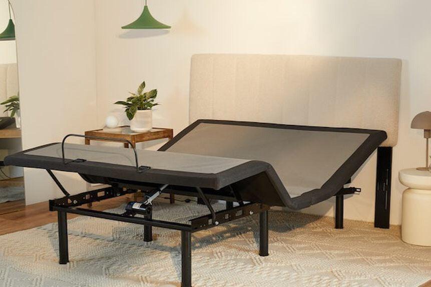 A Bliss Attachable Headboard, cream color, attached to an adjustable bed frame.