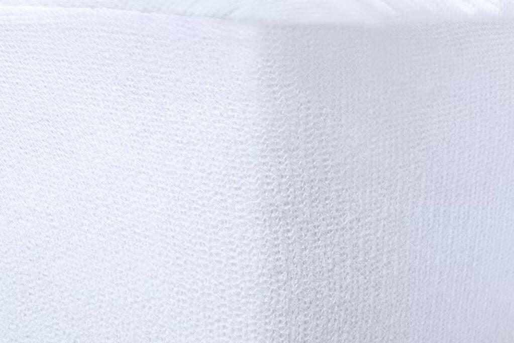 Close-up of waterproof mattress protector fabric on the side of a mattress