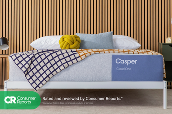 Casper's Cloud One mattress on a bed frame with pillows and a blanket folded on top. Text on the image says "Consumer Reports. Rated and reviewed by Consumer Reports. *Consumer Reports does not endorse products or services."