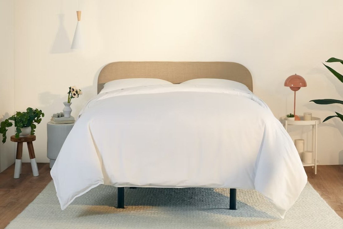 A fully made bed with a Drift Attachable Headboard, Taupe color. Front view.