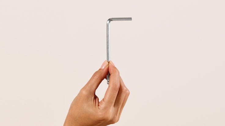 Close-up of someone's hand holding an Allen Wrench