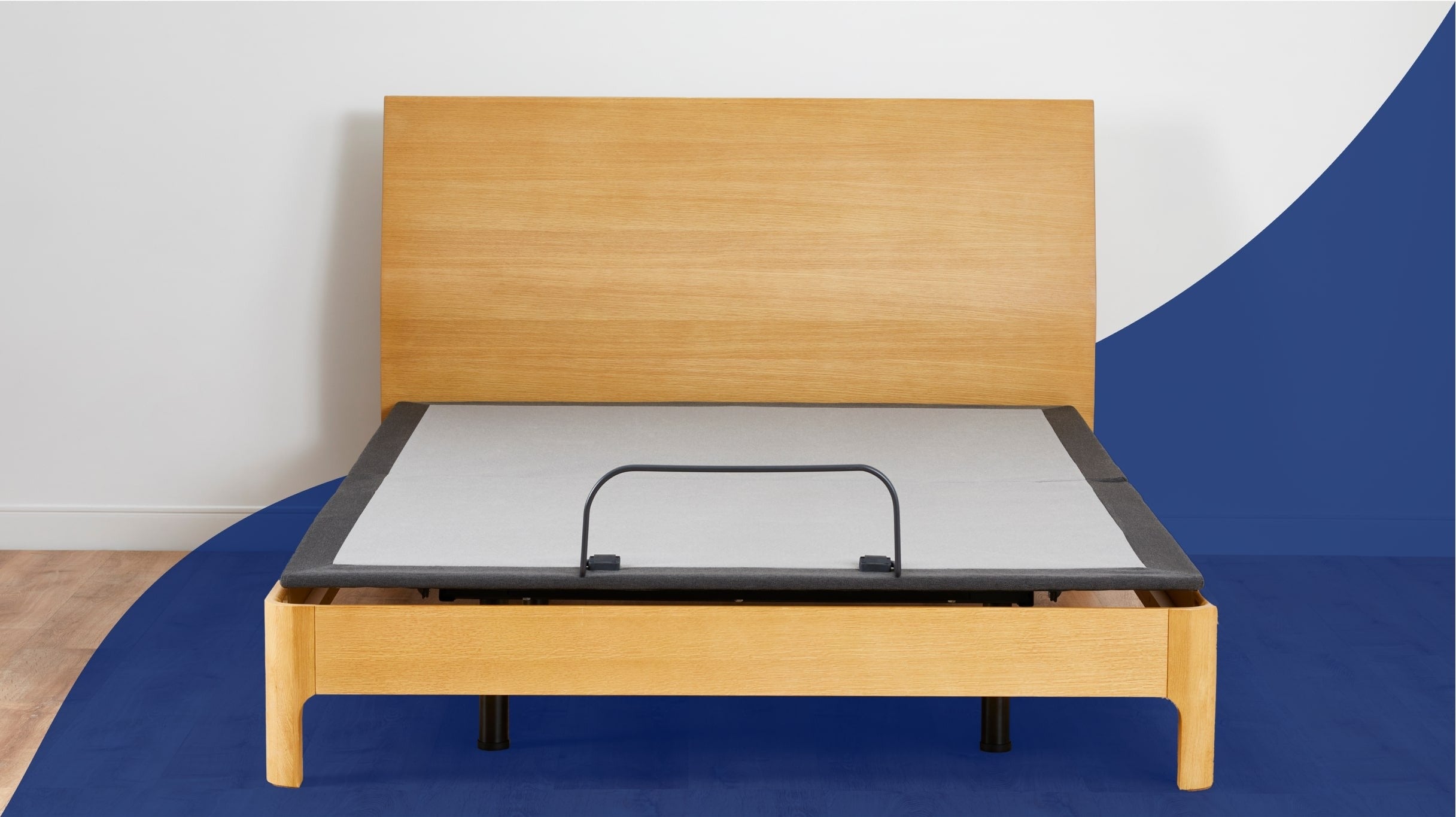 An adjustable base wrapped within a wooden bed frame and headboard. Front view.