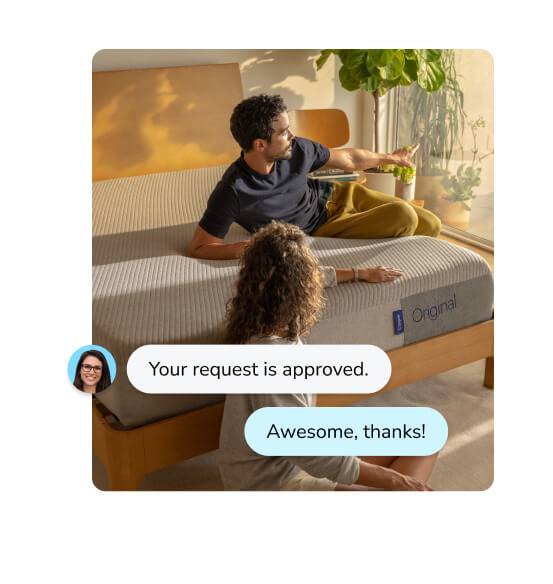 A man sits and leans on his Casper mattress. A woman is sitting cross-legged on the floor next to him. Imposed on the image is a computer image of a chat specialist saying "Your request is approved," with a customer response of "Awesome, thanks!"