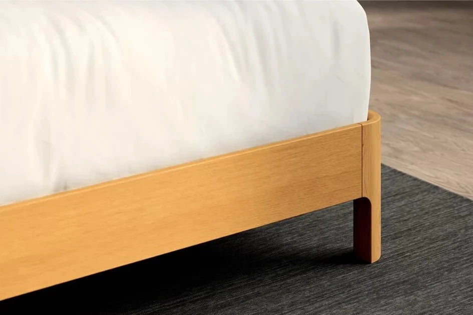 Close-up of the corner of a Repose Bed Frame with a mattress on it.
