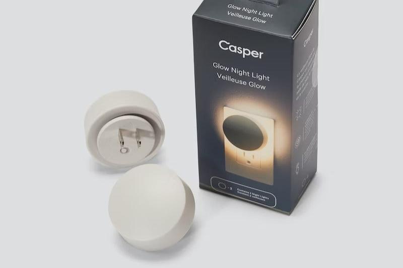 A manufacturer's image of Casper's Glow Nightlight, sitting next to its packaging box.