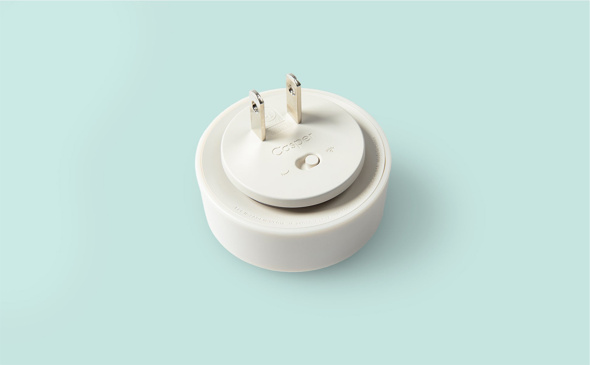 Close-up image of the back of a Glow Nightlight with two prongs that plug into the wall.