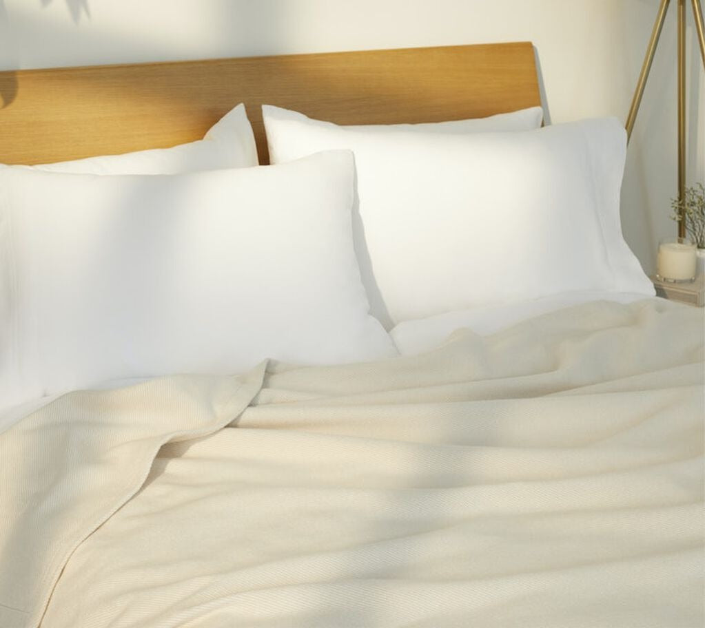 Cozy Woven Blanket, cream, on a mattress