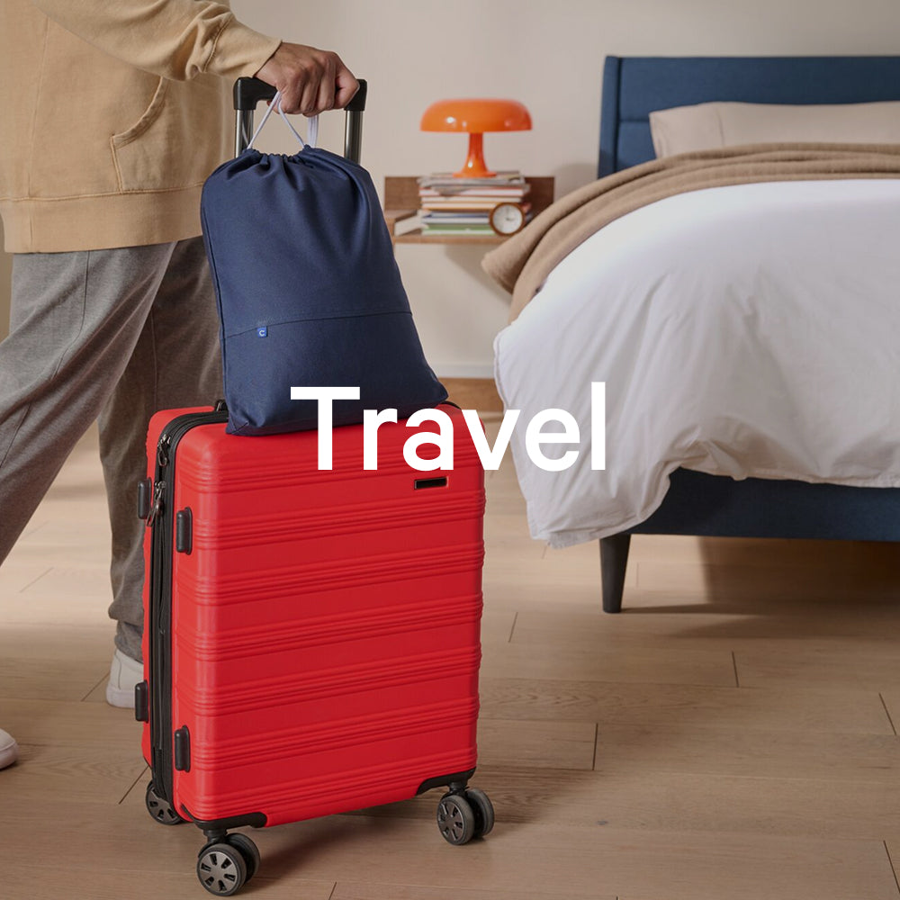 The word "travel" appears on an image of a person holding a suitcase with their Nap Pillow in its carrying bag on top of the suitcase.