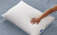 A hand feeling the Casper Original Pillow
