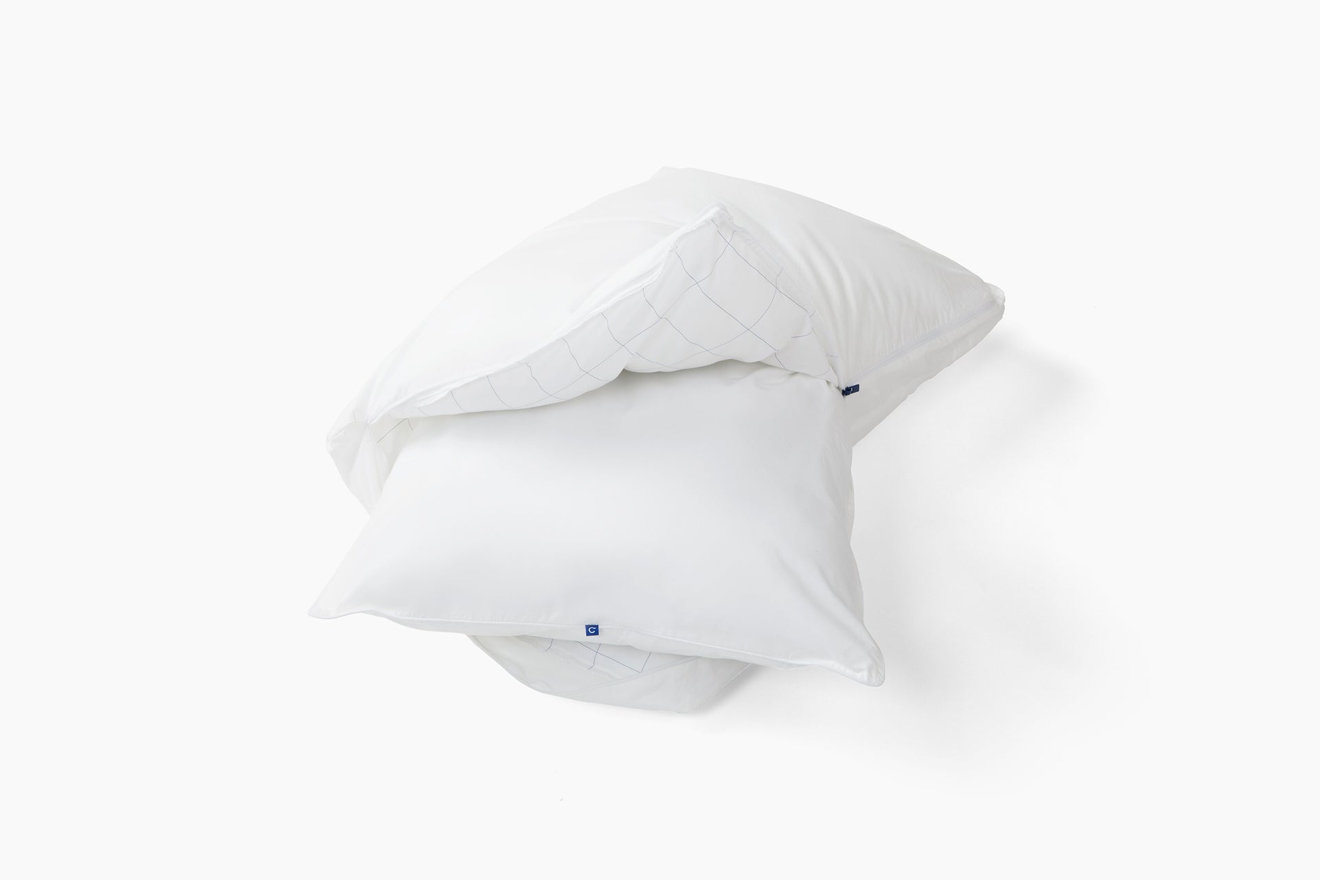 Original Pillow against a white background. The outer pillow is unzipped with the inner pillow sticking out of it.