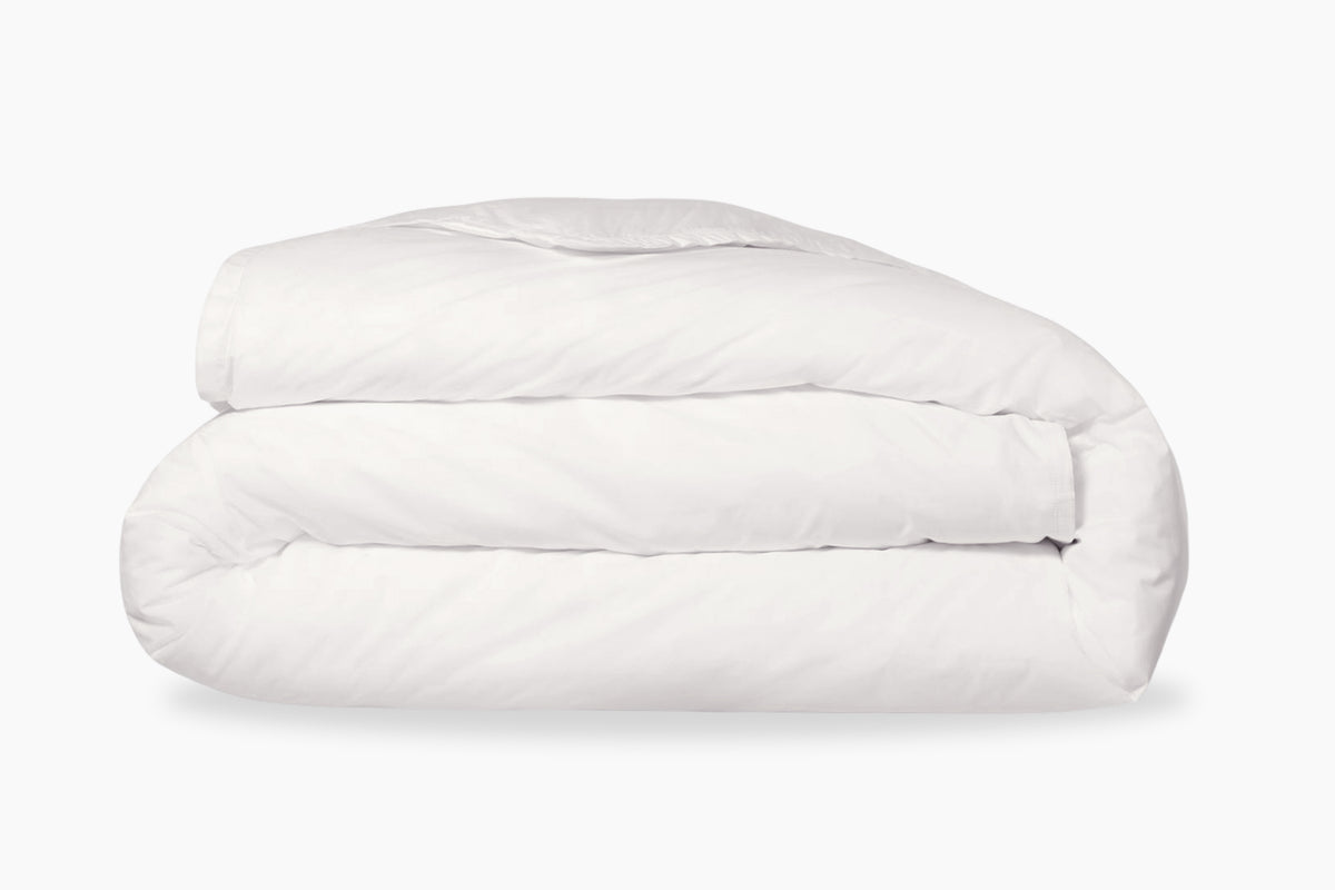 A folded, white duvet cover against a white background