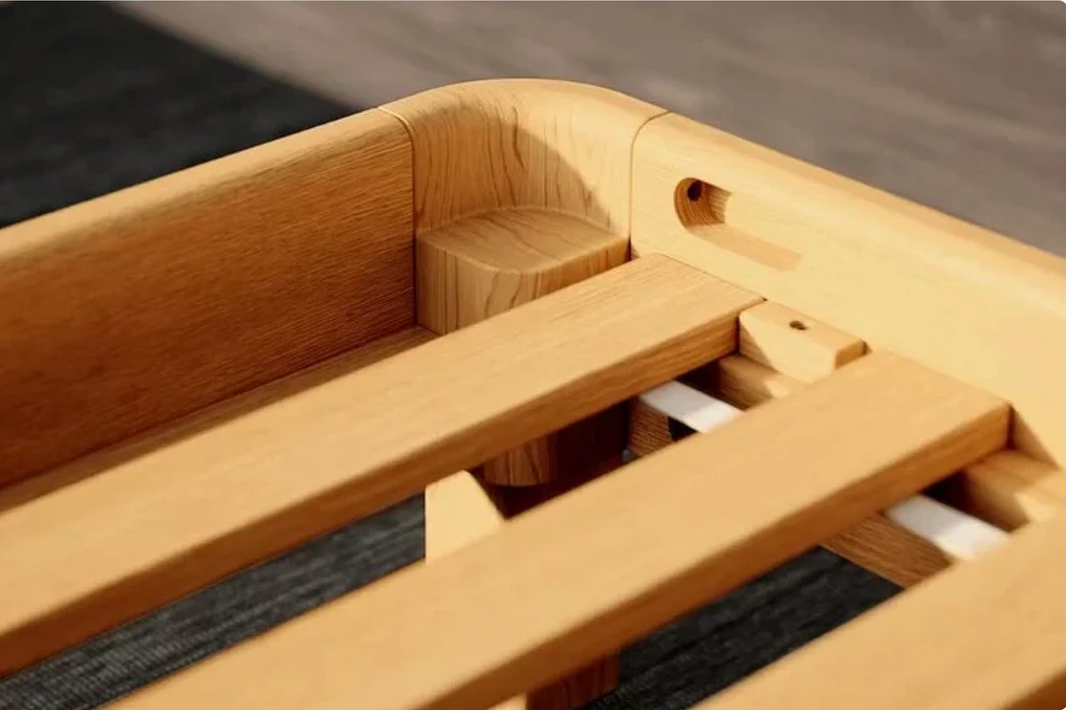 Close-up of a natural wooden bed frame corner with slats and a visible peg-lock joint, photographed indoors on a dark rug.
