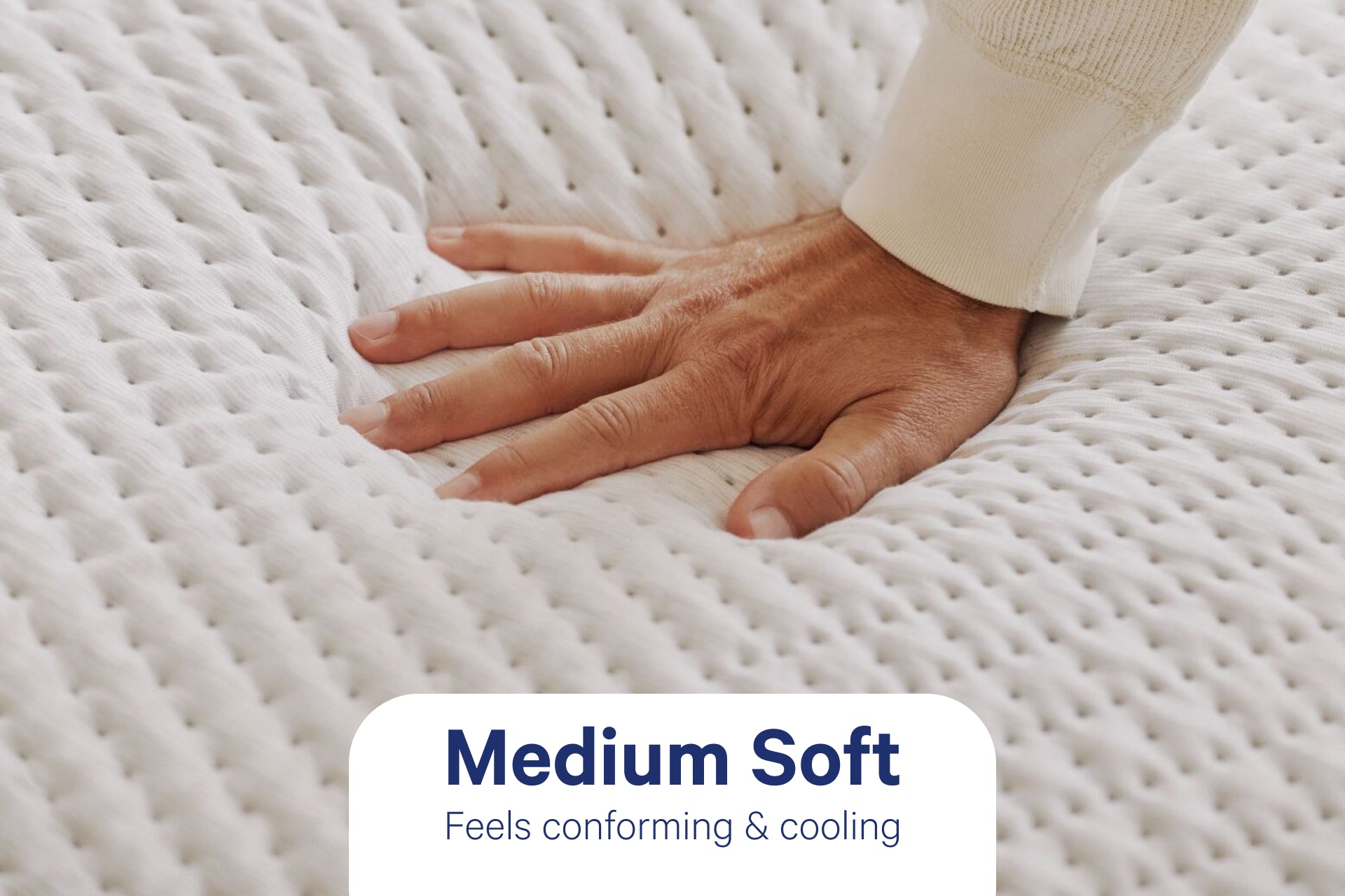 A person's hand pressing down to feel the Snow Max mattress. Text on the image indicates that its firmness level is Medium Soft and feels conforming & cooling.