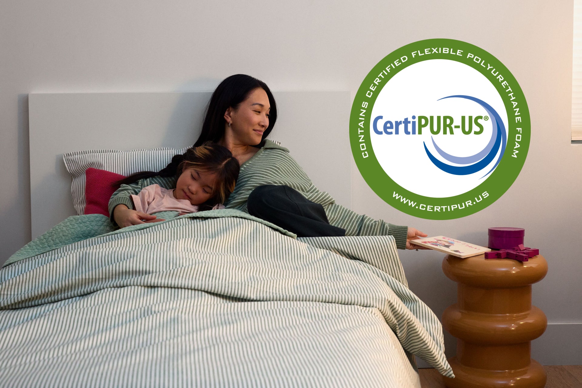 Woman and child lying in bed. A CertiPUR-US logo is overlaid on the image.