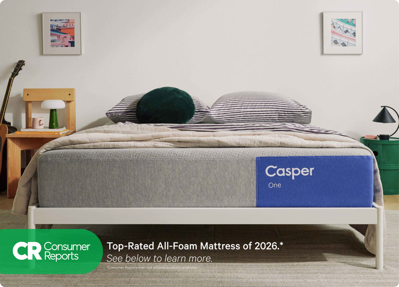 Casper's The One mattress on a bed frame with a blanket and pillows on top in a bedroom setting. At the bottom of the image is the Consumer Reports logo. The One is the top-rated all-foam mattress of 2026. See below to learn more. Consumer Reports does not endorse products or service.