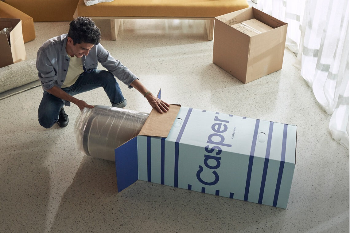 A person unboxing his Casper mattress.