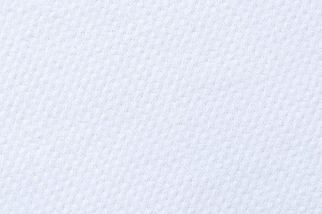 Close-up of waterproof mattress protector fabric above mattress