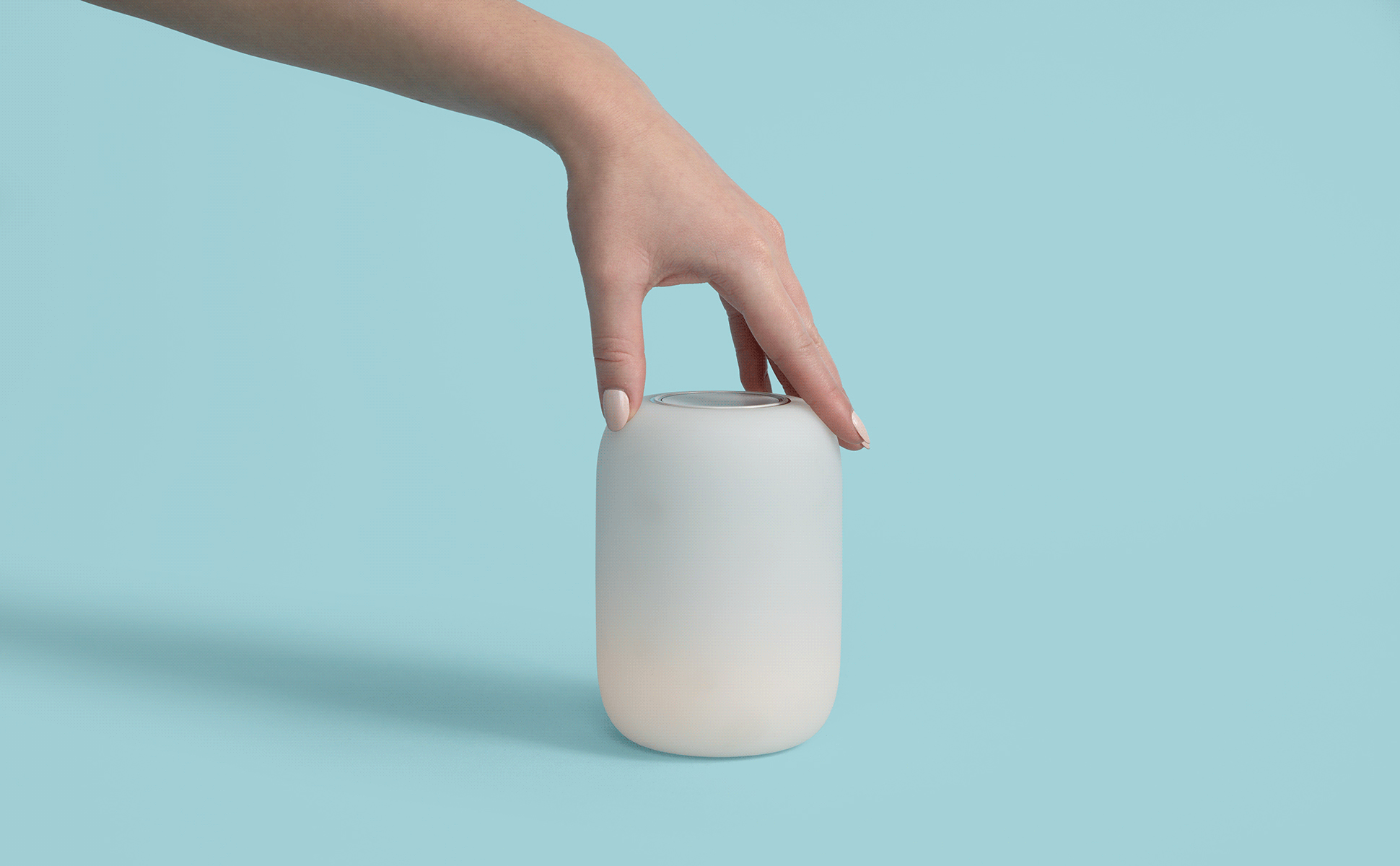 GIF of a Glow Light being rotated and turned on by someone's hand