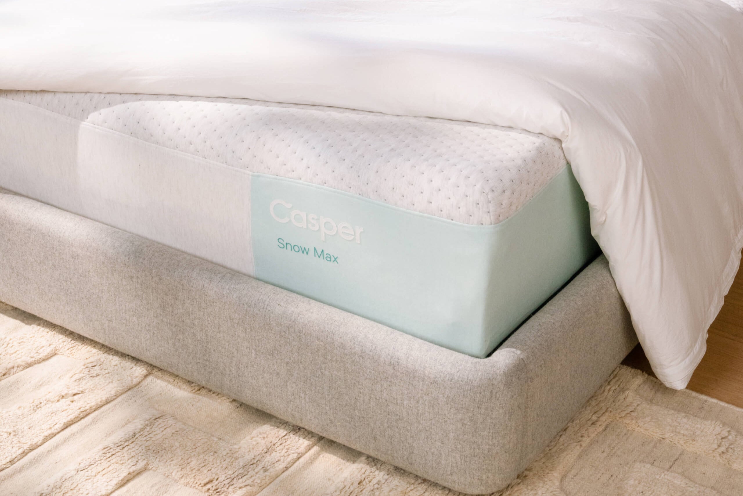 Snow Max mattress on Haven bedframe with duvet draped over