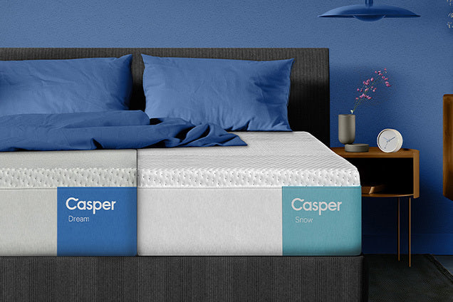 Front view of a bed with split king size mattresses on it: a Casper Dream and a Casper Snow.