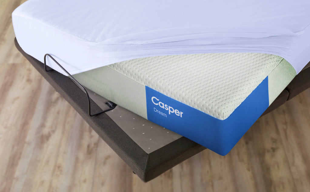 mattress protector covering a mattress on an adjustable bed frame