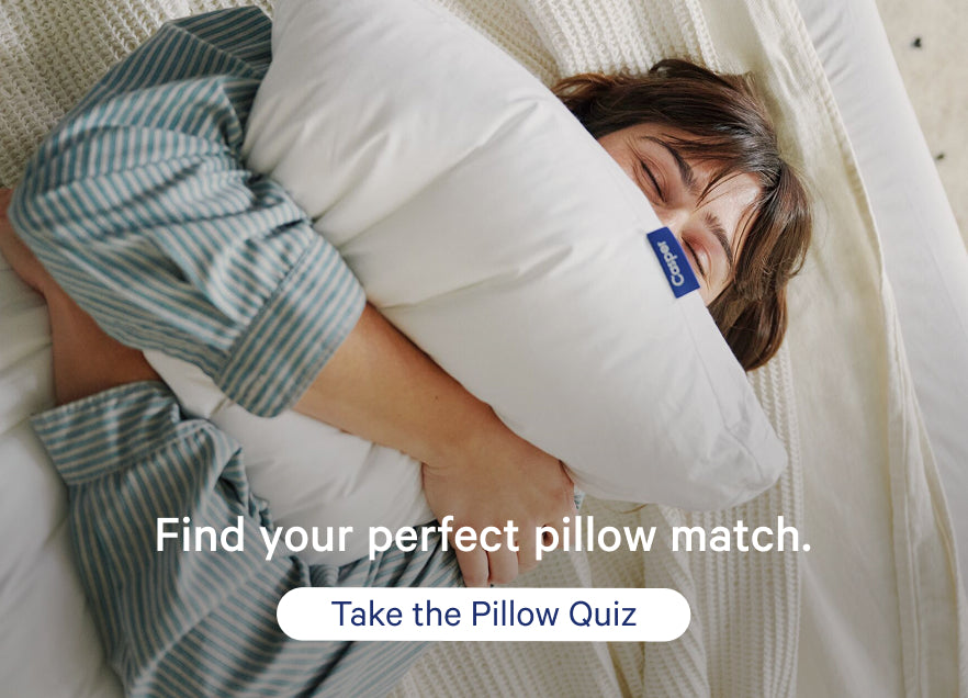 Person lying on a mattress and squeezing a pillow with promotional text overlay that says, "Find your perfect pillow match. Take the Pillow Quiz."