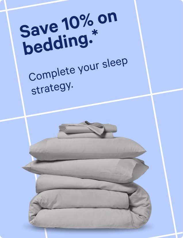 A stack of light gray bedding, including pillows, a duvet cover, and folded sheets, displayed on a light blue background with promotional text reading 'Save 10% on bedding. Complete your sleep strategy.'