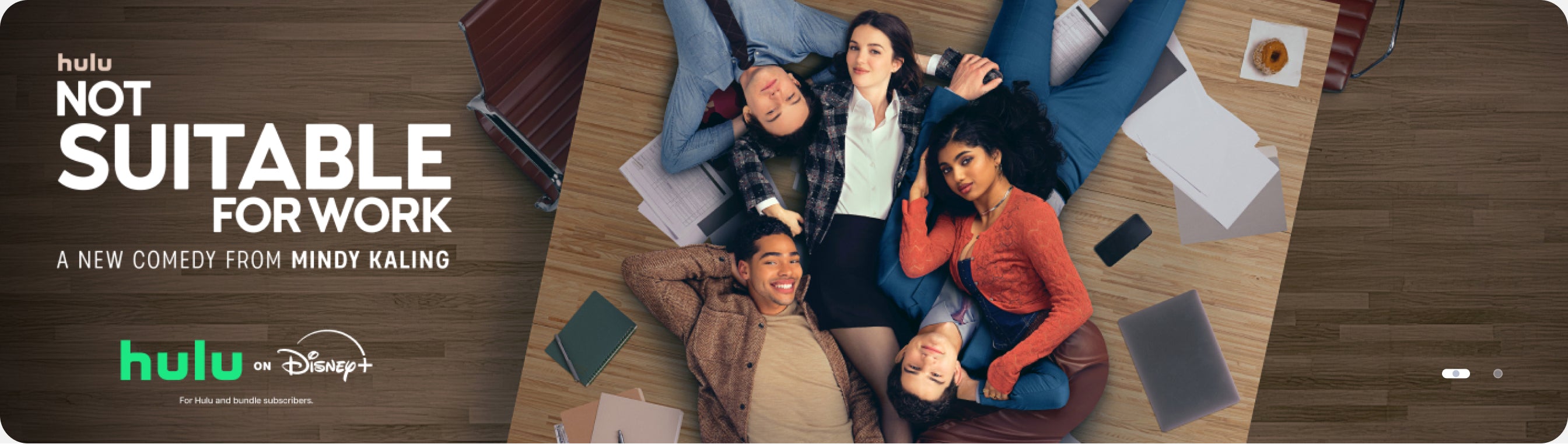 Promotional poster for 'Not Suitable for Work' with Hulu branding and a group of people sitting on the floor.