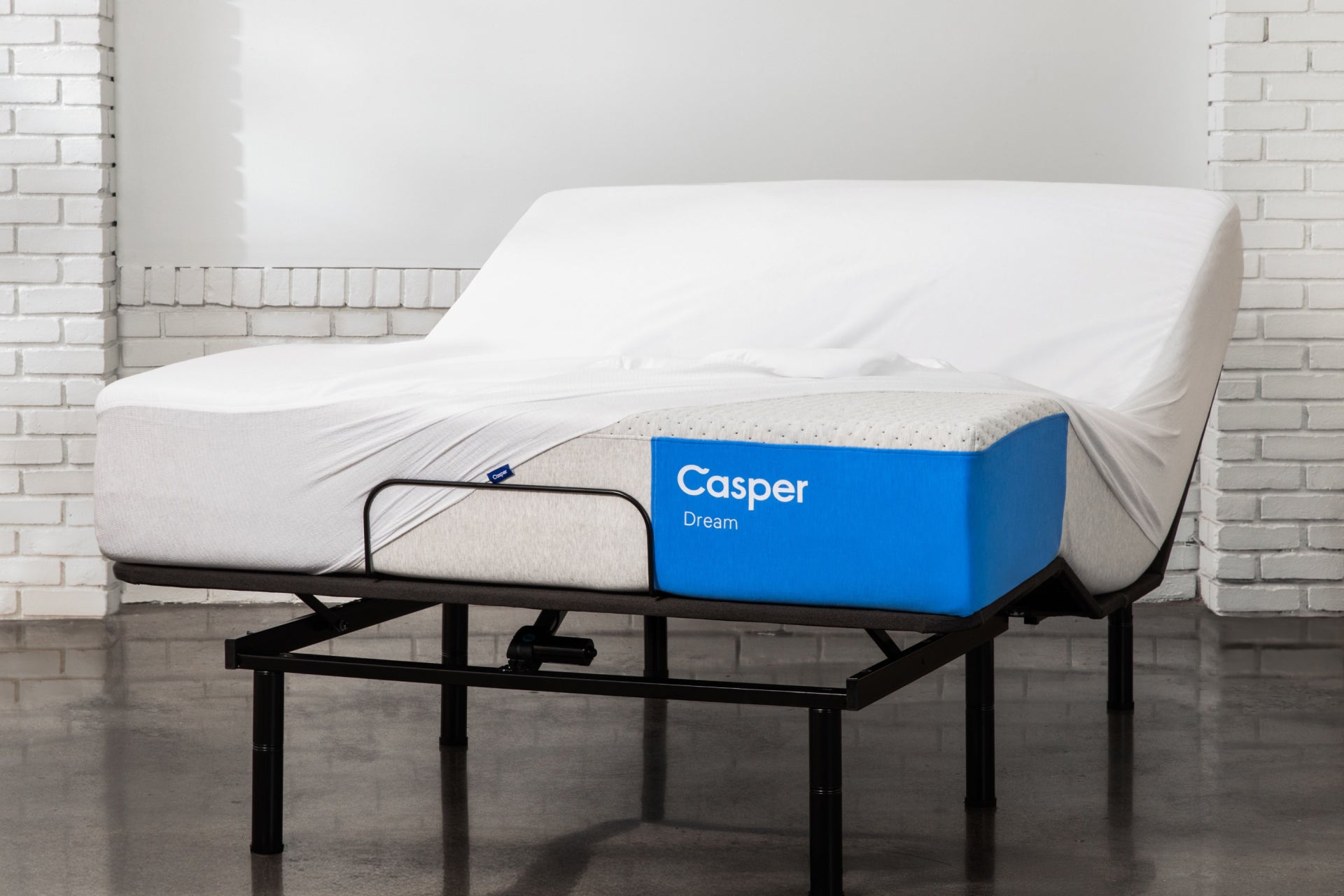 A waterproof mattress protector on Casper's Dream mattress on an adjustable bed frame