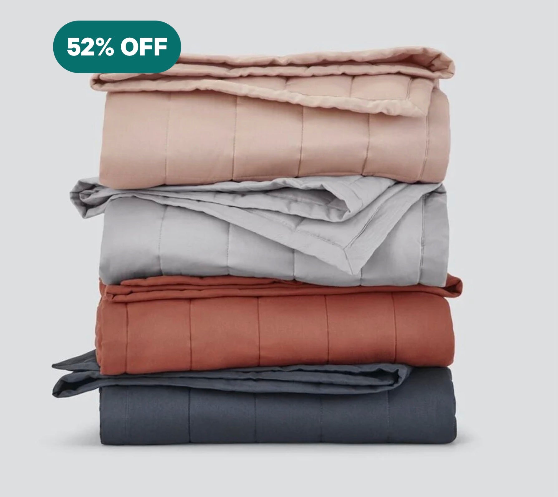 A stack of various colored Weighted Blankets.