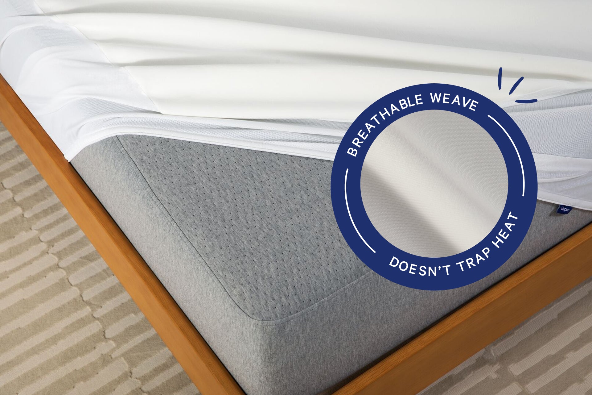 Corner view of the Breathable Mattress Protector over a mattress. A badge on the image says "Breathable weave. Doesn't trap heat."