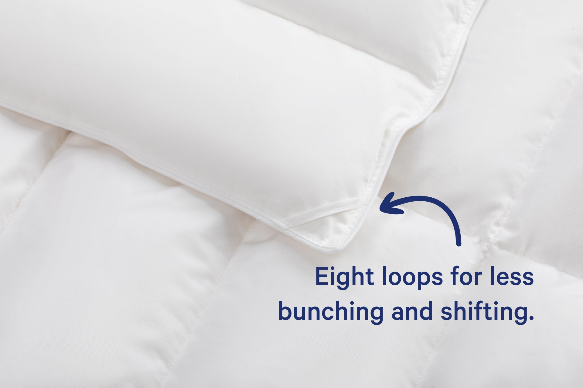 Close-up of the corner of the Down Alt Duvet. Text on the image says "Eight loops for less bunching and shifting."