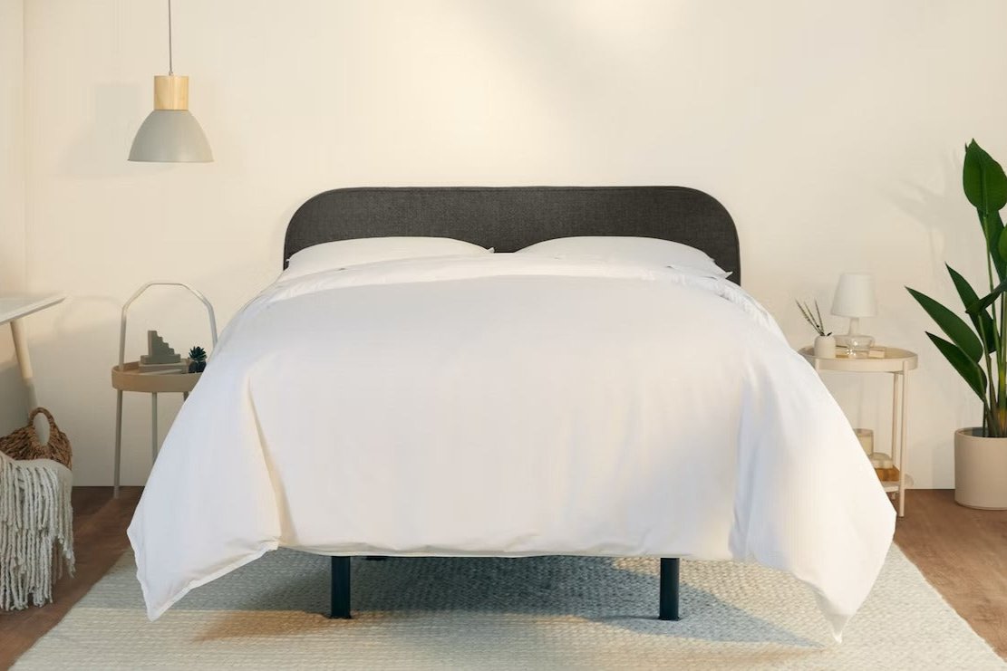 A fully made bed with a Drift Attachable Headboard, Slate color. Front view.