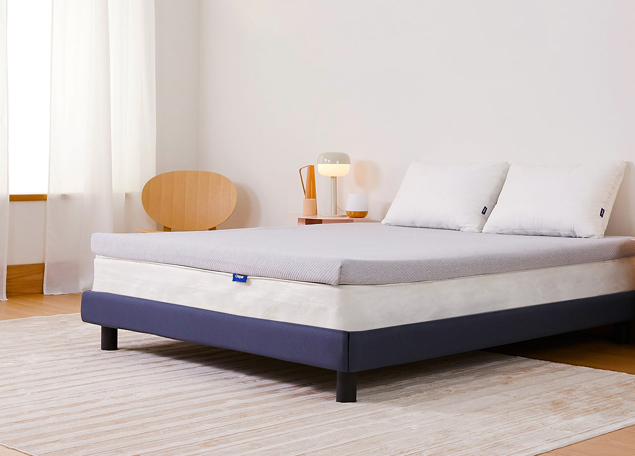 Casper's Essential Topper on a queen mattress. Corner view.