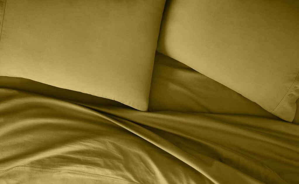 Close-up of Olive Flannel products on a bed