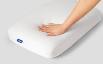 A hand feeling the Casper Foam Pillow with Snow Technology