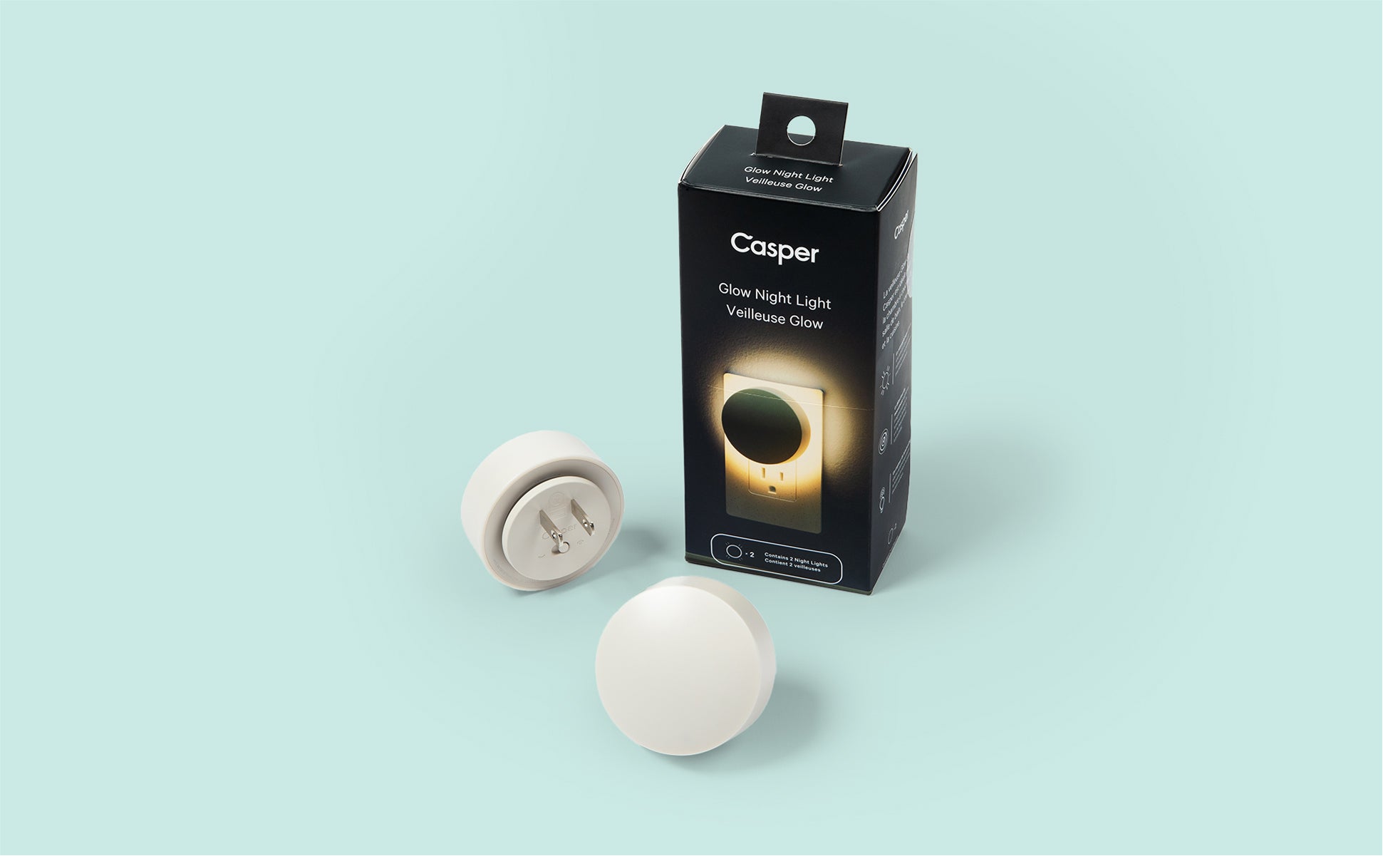 Image of two Glow Nightlights sitting in front of the box they came in.
