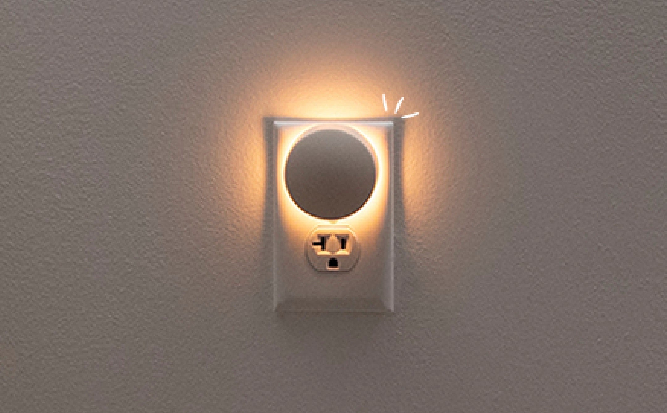 Close-up image of the Glow Nightlight plugged into wall outlet and turned on.