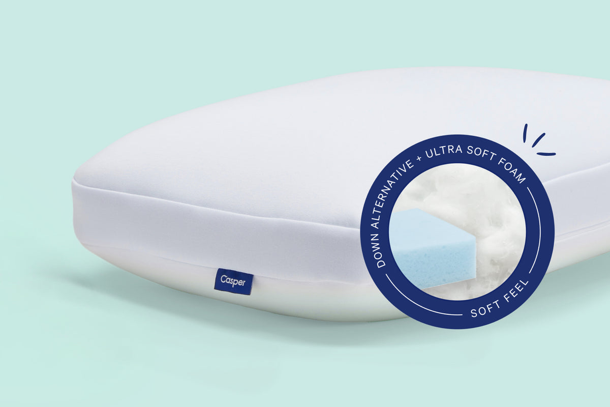 Casper's Hybrid Pillow against a light green background. A pill on the image indicates that it has down-alternative fill and ultra soft foam with a soft feel.