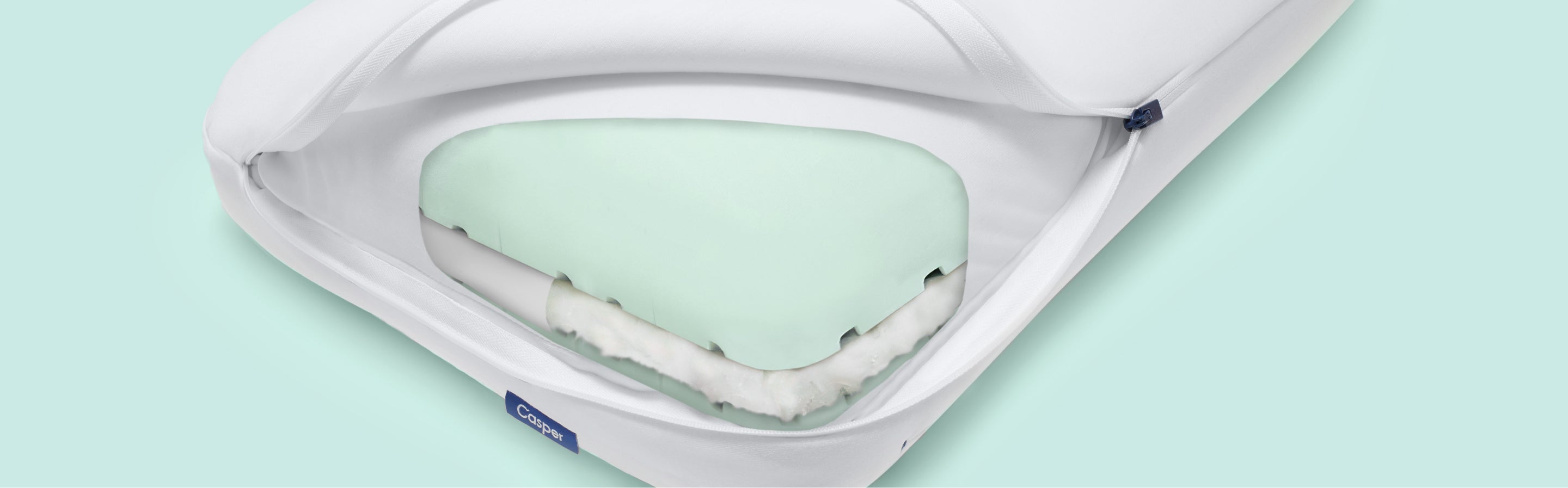Casper's Hybrid Pillow with its outer layer unzipped and flapped open to reveal inner layers