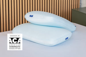 Casper's Hybrid Snow Pillow Double Pack on a mattress. A badge on the image says "Endorsed by the ACA - American Chiropractic Association."