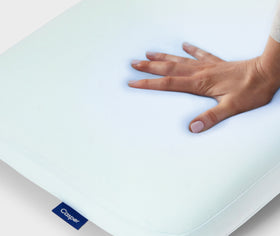 A hand feeling the Hybrid Pillow with Snow Technology.