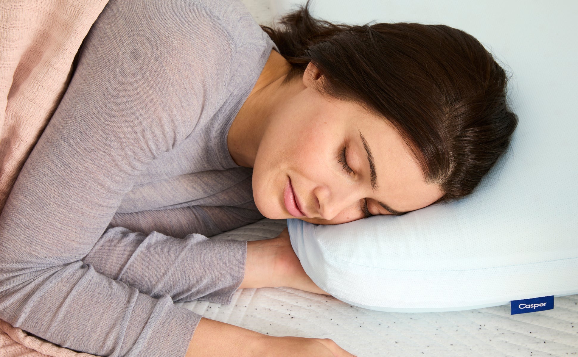 Close-up image of a person lying their head on the Hybrid Pillow with Snow Technology