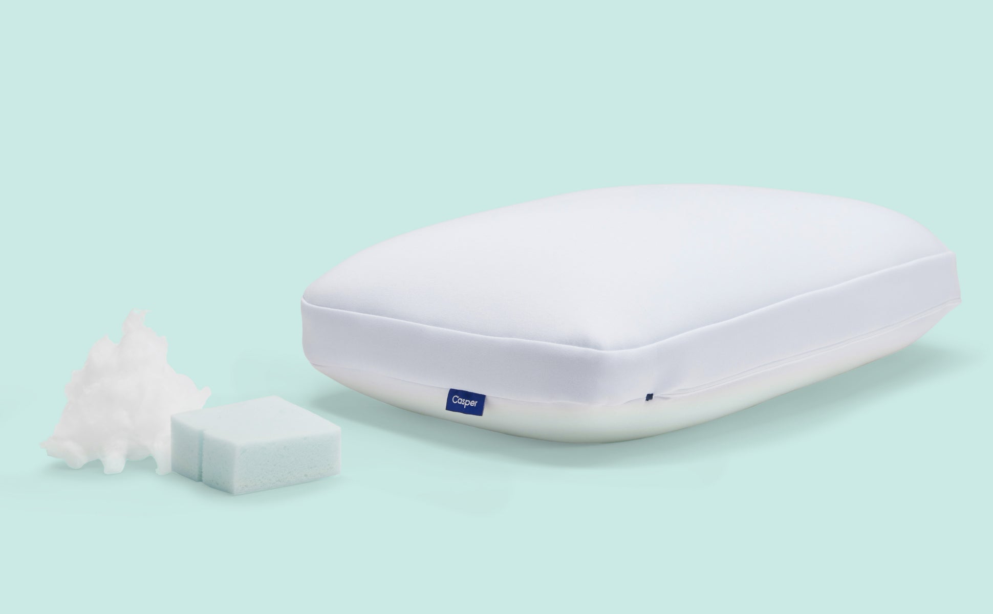 Casper's Hybrid Pillow. A portion of the pillow's inner foam and fibers sit next to the pillow.