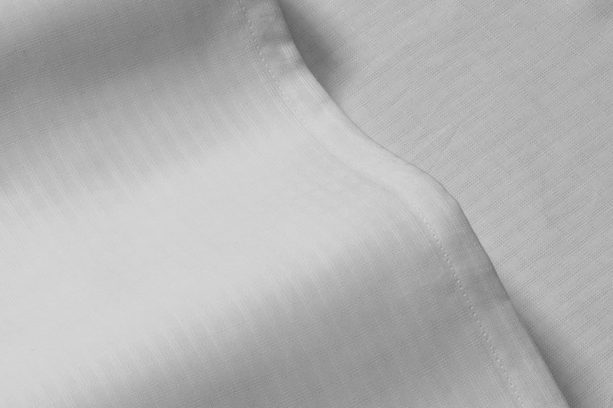 Close-up detail of a gray bed sheet