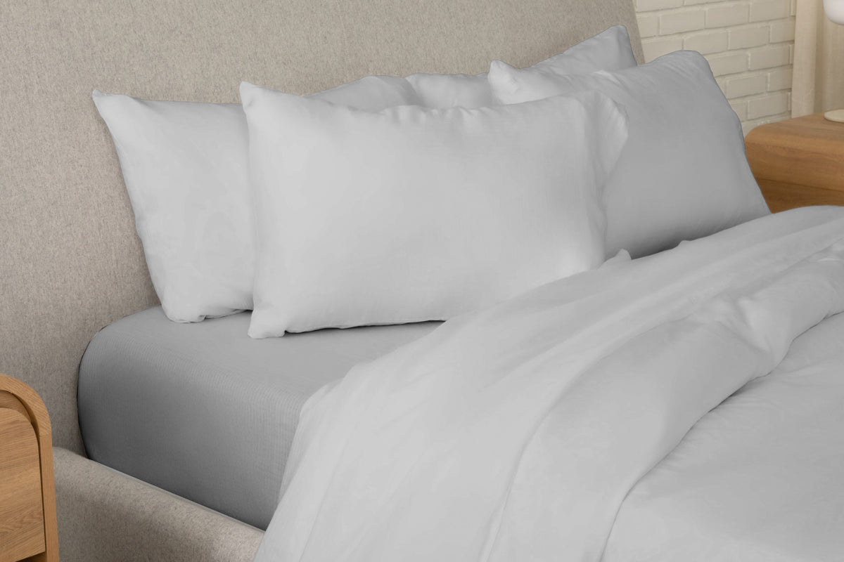 Fully dressed bed with gray sheets
